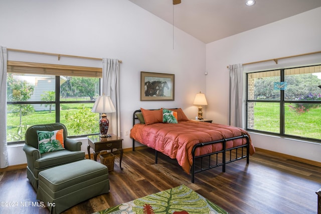 bedroom with dark wood-type flooring, high vaulted ceiling, and multiple windows