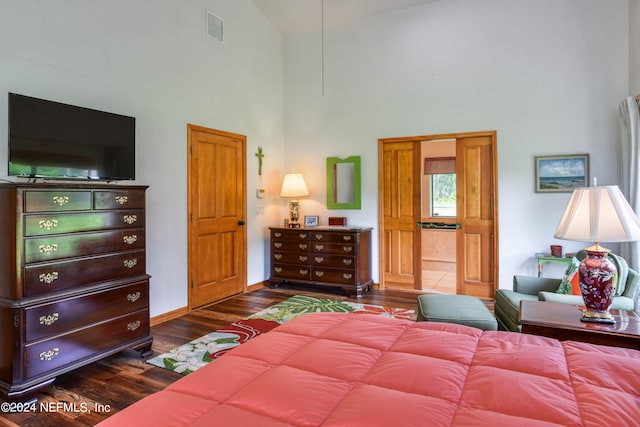 bedroom featuring dark hardwood / wood-style floors and high vaulted ceiling