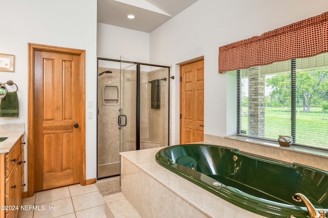 bathroom featuring tile patterned floors, vanity, and plus walk in shower