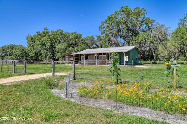 view of front of home featuring a rural view and an outdoor structure