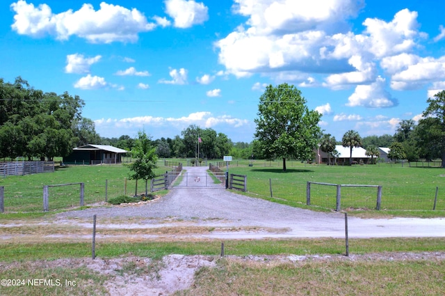 view of property's community with a lawn and a rural view