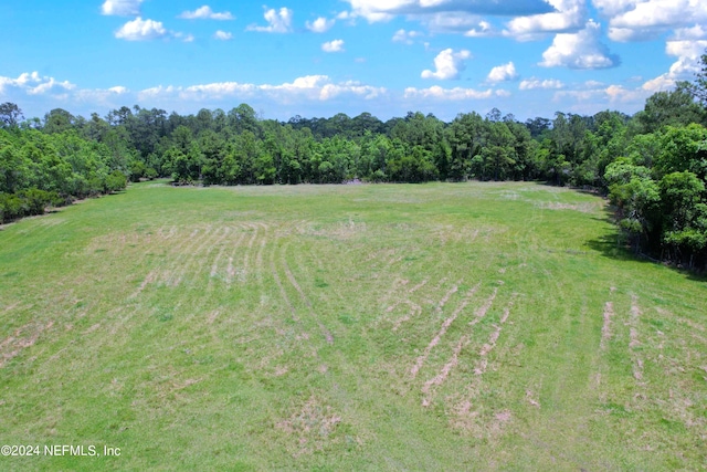 birds eye view of property with a rural view