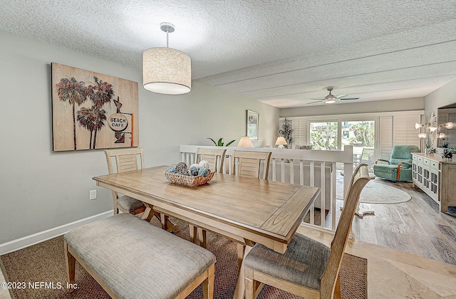 8550 A1A Unit 12122, Saint Augustine, FL 32080 - dining room with ceiling fan with notable chandelier, a textured ceiling, and wood-type flooring