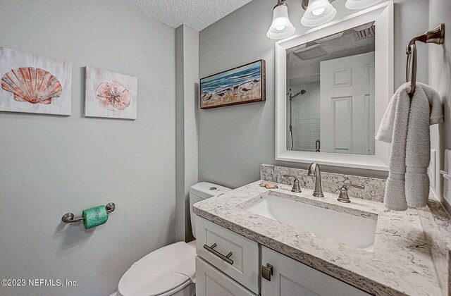 8550 A1A Unit 12122, Saint Augustine, FL 32080 - bathroom with a textured ceiling, vanity, and toilet