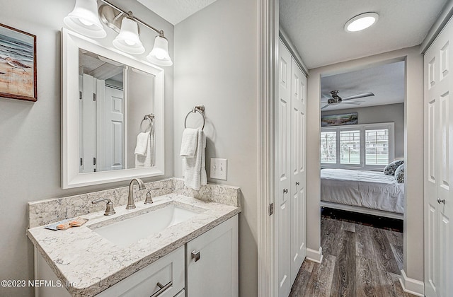 8550 A1A Unit 12122, Saint Augustine, FL 32080 - bathroom featuring hardwood / wood-style flooring, vanity, a textured ceiling, and ceiling fan