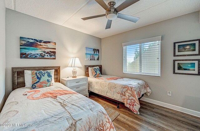 8550 A1A Unit 12122, Saint Augustine, FL 32080 - bedroom featuring dark hardwood / wood-style floors, ceiling fan, and a textured ceiling