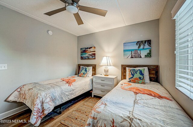 8550 A1A Unit 12122, Saint Augustine, FL 32080 - bedroom featuring ceiling fan, light hardwood / wood-style flooring, a textured ceiling, and multiple windows
