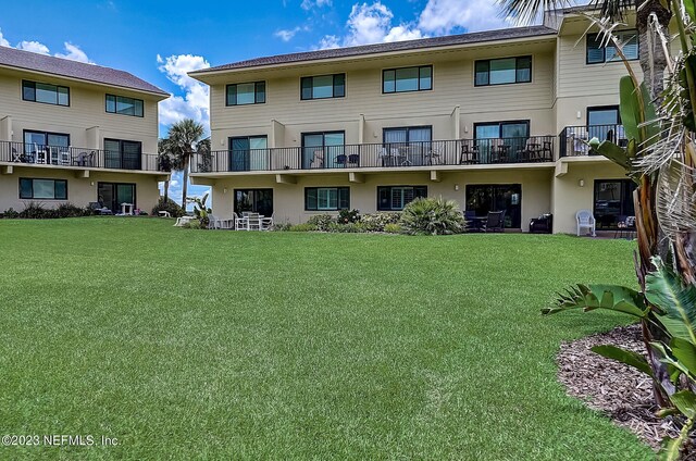 8550 A1A Unit 12122, Saint Augustine, FL 32080 - back of house with a lawn and a balcony