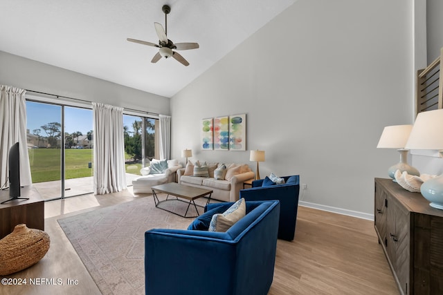 living room with ceiling fan, high vaulted ceiling, and light hardwood / wood-style flooring