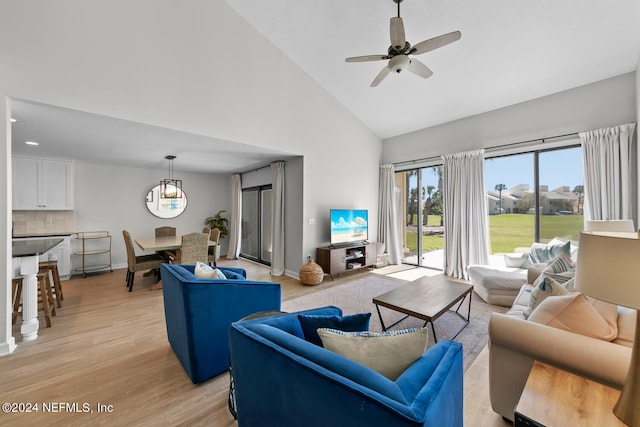 living room with ceiling fan, high vaulted ceiling, and light hardwood / wood-style floors