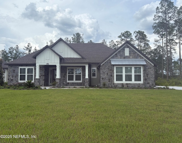 36250 Pitch Ln, Hilliard, FL 32046 - craftsman inspired home featuring stone siding, board and batten siding, a front lawn, and a shingled roof