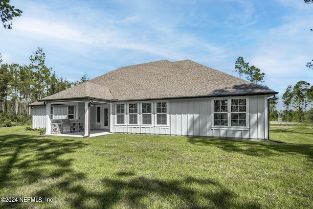 back of property featuring a patio area and a lawn