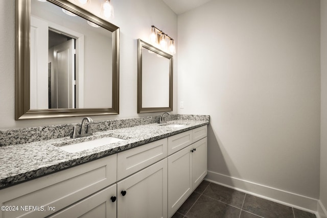 bathroom featuring double vanity and tile flooring