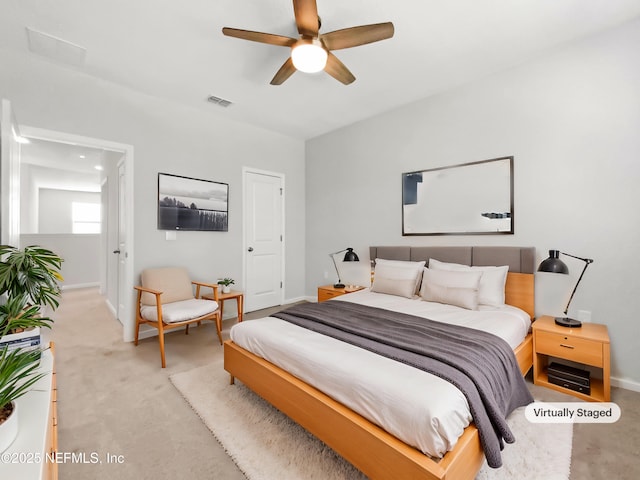 bedroom with ceiling fan and light carpet