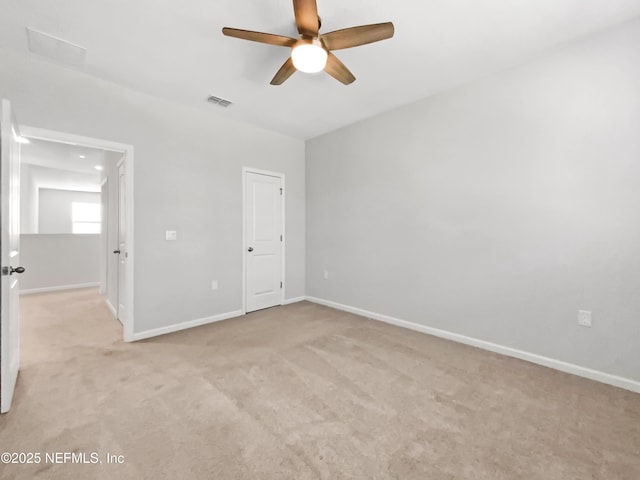 unfurnished bedroom featuring light carpet and ceiling fan