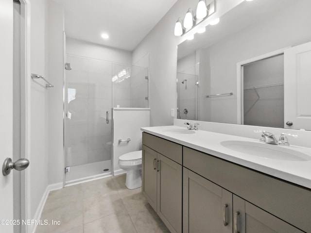 bathroom featuring tile patterned floors, an enclosed shower, vanity, and toilet