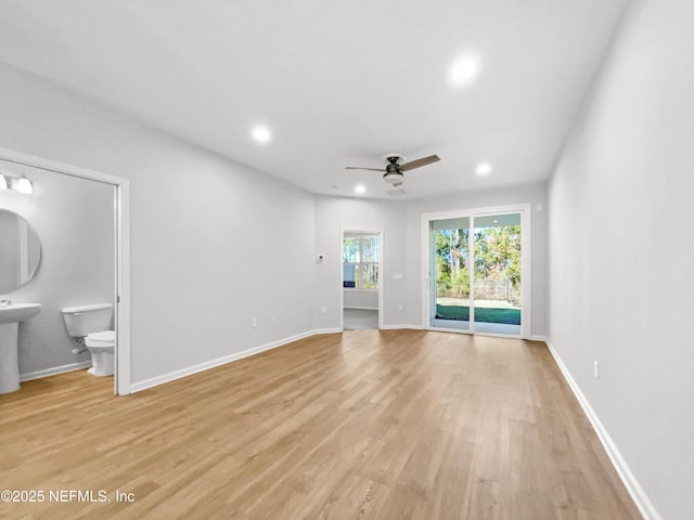 unfurnished living room with ceiling fan and light hardwood / wood-style floors