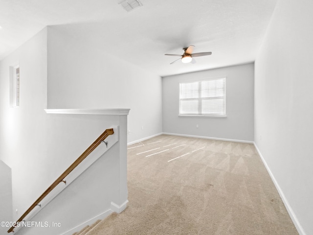 unfurnished living room with ceiling fan and light carpet