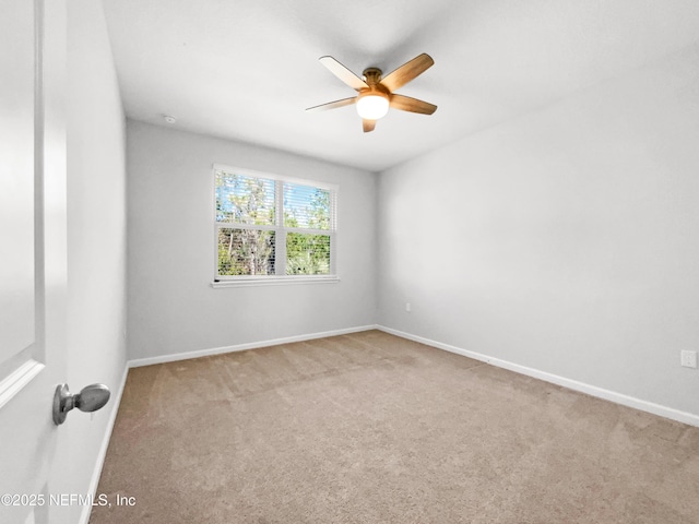 unfurnished room featuring ceiling fan and light carpet