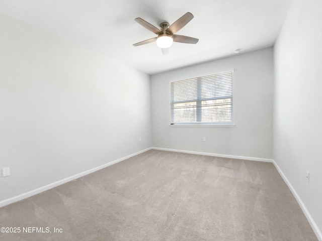 unfurnished room with ceiling fan and carpet