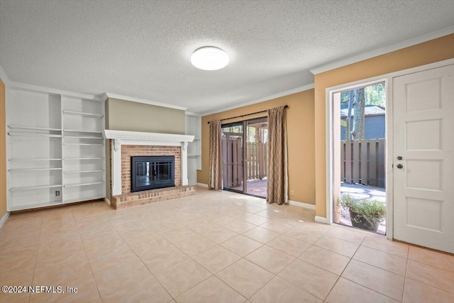 unfurnished living room featuring a textured ceiling, a brick fireplace, and light tile floors