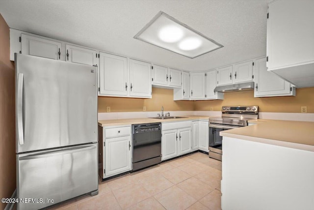 kitchen featuring light tile floors, white cabinetry, appliances with stainless steel finishes, sink, and a textured ceiling