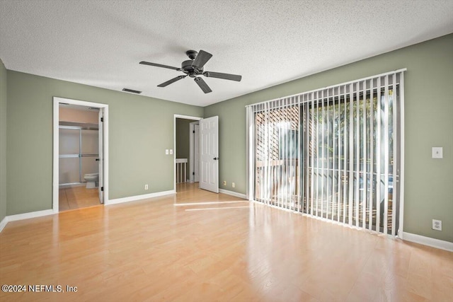 unfurnished bedroom with ceiling fan, access to exterior, a textured ceiling, and light tile floors