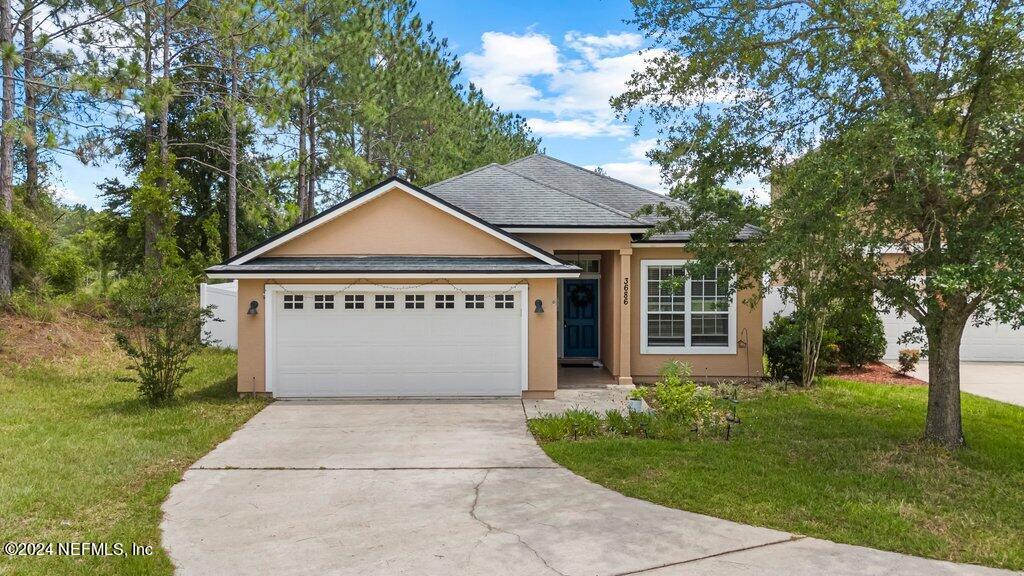 single story home with a front lawn and a garage