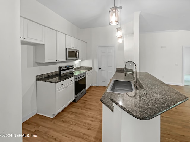 kitchen featuring stainless steel appliances, sink, pendant lighting, light hardwood / wood-style flooring, and white cabinetry