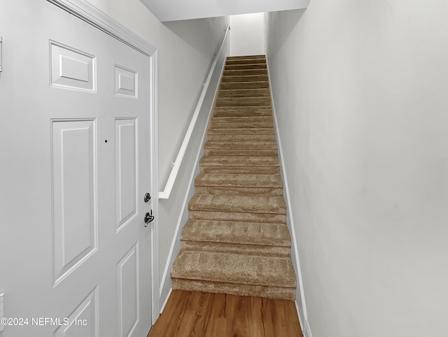 stairs with hardwood / wood-style floors