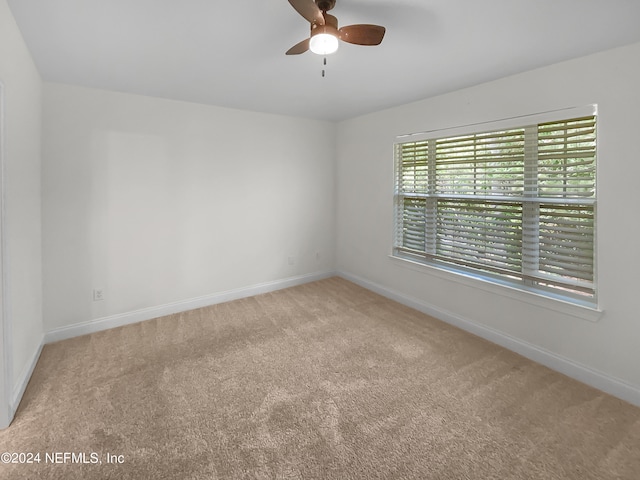 unfurnished room with ceiling fan and carpet floors