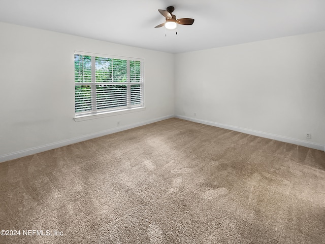 empty room with ceiling fan and carpet floors