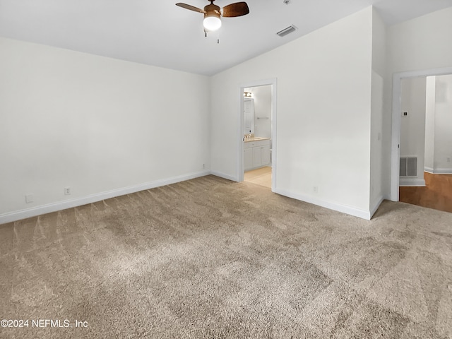 carpeted empty room with vaulted ceiling and ceiling fan