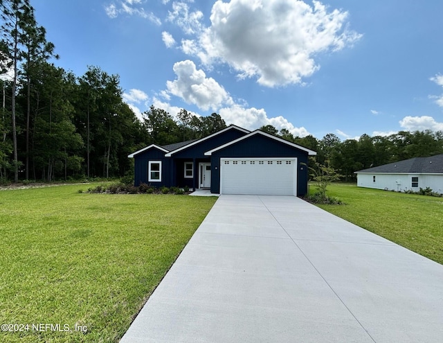 view of front of property featuring a front lawn and a garage