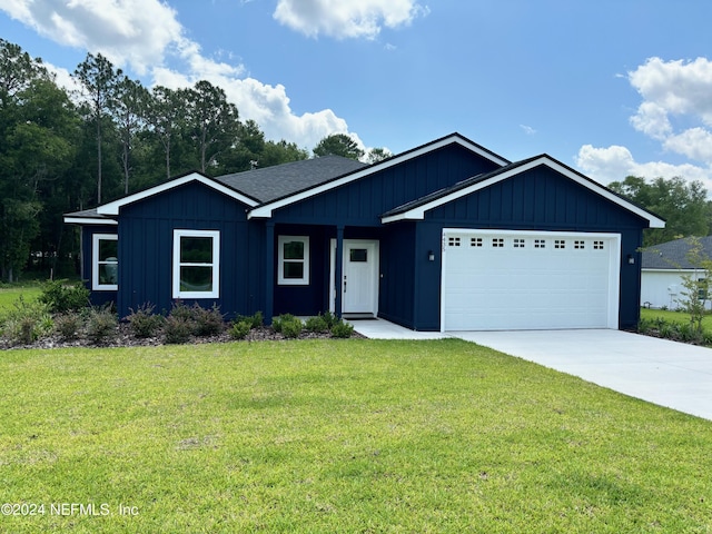 view of front of house with a garage and a front lawn