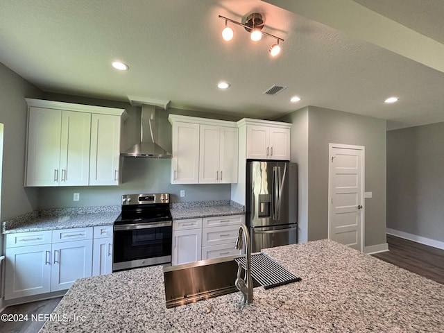 kitchen with white cabinetry, sink, wall chimney range hood, and appliances with stainless steel finishes