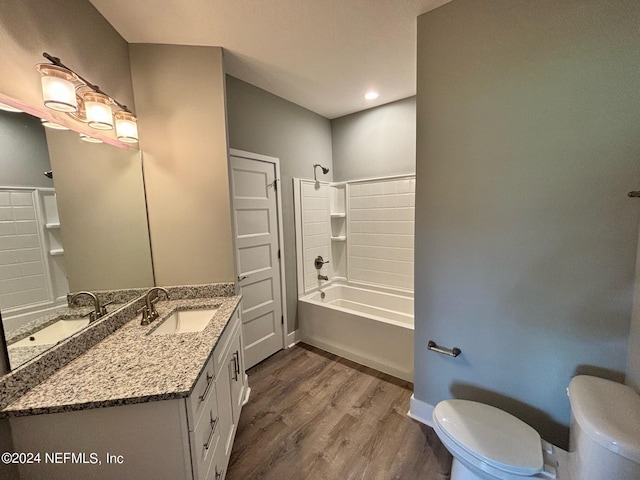 full bathroom with hardwood / wood-style flooring, shower / bath combination, toilet, and vanity