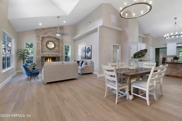 dining area with plenty of natural light, high vaulted ceiling, and light hardwood / wood-style flooring