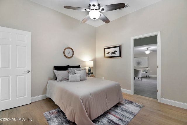 bedroom featuring ceiling fan and light hardwood / wood-style flooring