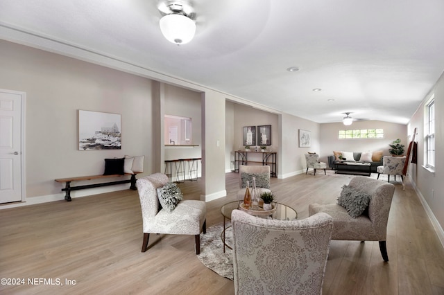 living room featuring light hardwood / wood-style floors and vaulted ceiling