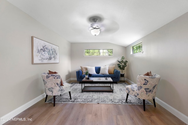 sitting room with ceiling fan, wood-type flooring, and lofted ceiling