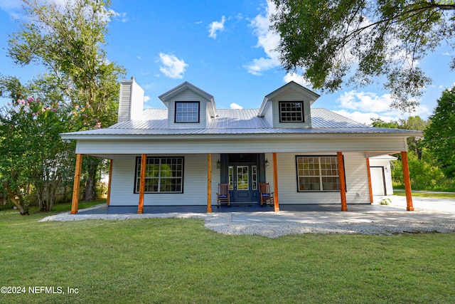 view of front of house with a porch, a garage, and a front lawn