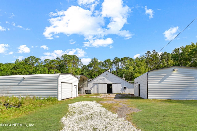 view of yard with an outdoor structure and a carport