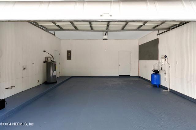 garage featuring electric water heater and electric panel