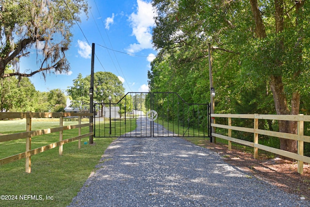 view of gate featuring a yard