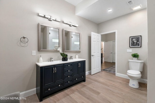 bathroom featuring hardwood / wood-style flooring, vanity, and toilet