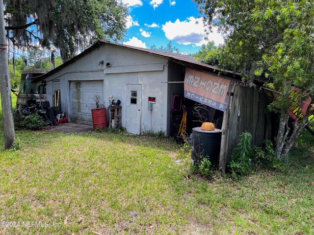 exterior space with a garage and a yard