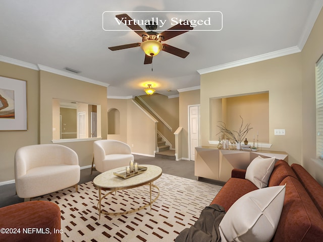 carpeted living room featuring ceiling fan and ornamental molding