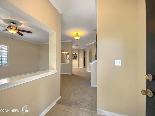 hall featuring light carpet and crown molding