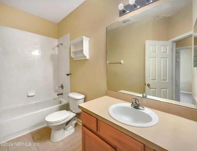 full bathroom featuring tile patterned flooring, vanity, toilet, and shower / washtub combination